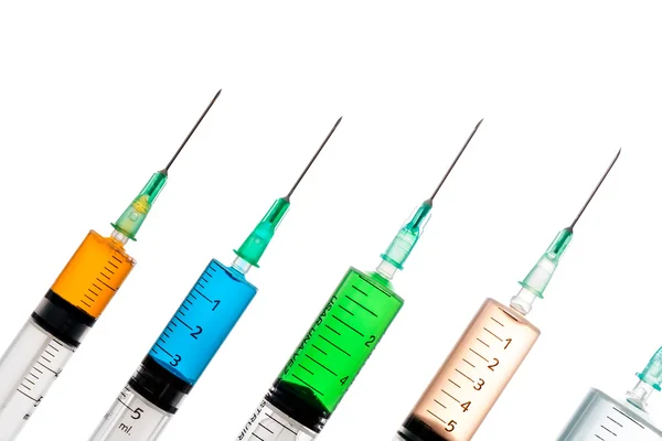 Various syringes filled with colored liquids — Stock Photo, Image