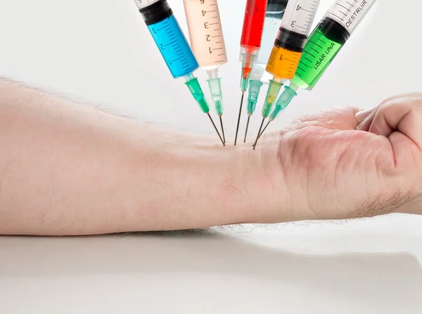 Various syringes filled with colored liquids — Stock Photo, Image