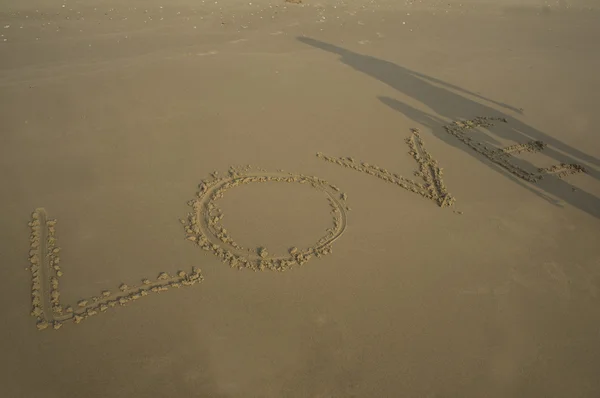 Love word beach sand write shadow — Stock Photo, Image