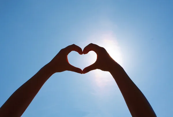 Girls heart hands on the sky — Stock Photo, Image