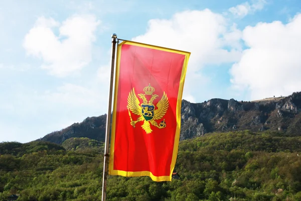 Montenegro flag in a front of mountains — Stock Photo, Image