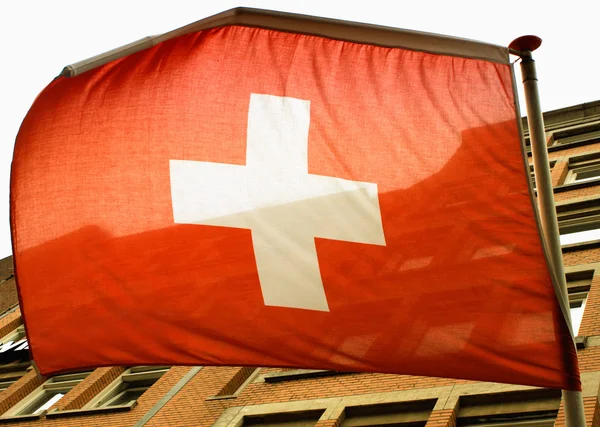 Waving Swiss flag on the wind — Stock Photo, Image