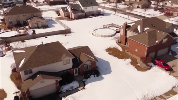 Aerial of homes in a snow covered suburban neighborhood — Stock Video