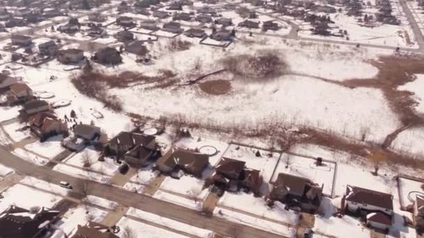 Aerial of homes in a snow covered suburban neighborhood — Stock Video