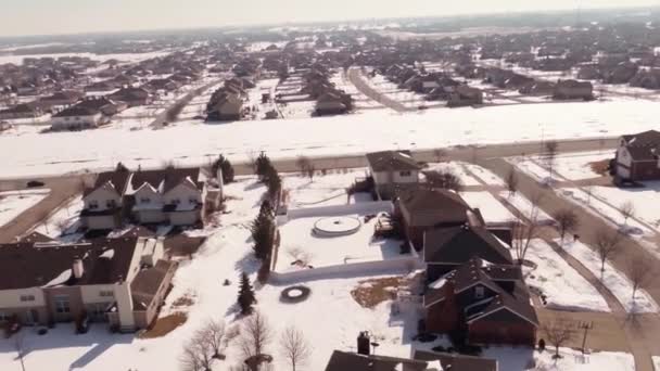 Aerial of homes in a snow covered suburban neighborhood — Stock Video