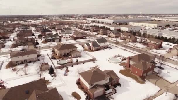 Aerial of homes in a snow covered suburban neighborhood — Stock Video