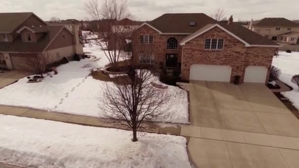 Aerial of homes in a snow covered suburban neighborhood — Stock Video