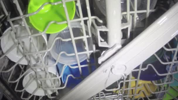 Washing dishes inside dish washer — Stock Video