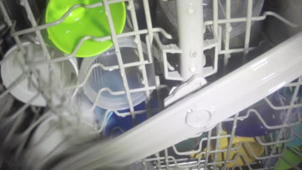 Washing dishes inside dish washer — Stock Video