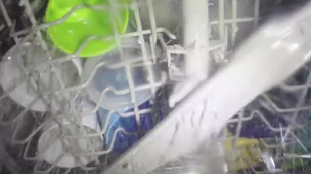 Washing dishes inside dish washer — Stock Video