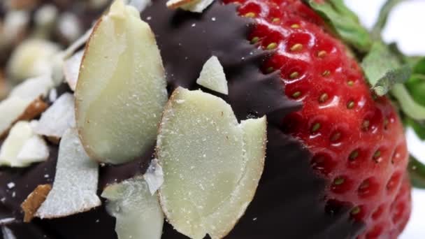 Strawberry dipped in chocolate covered with almond nuts — Stock Video