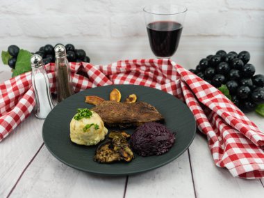 Kırmızı lahana ve orman mantarlı fırında ördek.