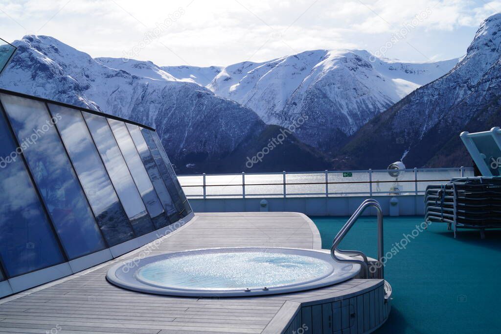 With a cruise ship in the fjords of norway