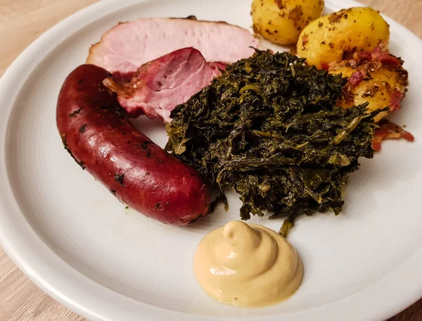 traditional northern german Food curly Kale with pork Bacon and sausages