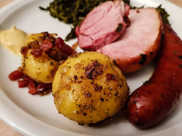 traditional northern german Food curly Kale with pork Bacon and sausages