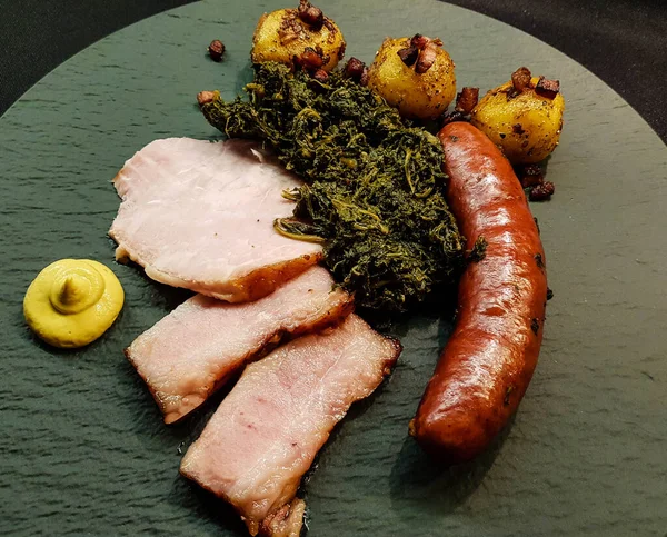 traditional northern german Food curly Kale with pork Bacon and sausages