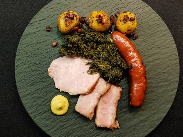 traditional northern german Food curly Kale with pork Bacon and sausages