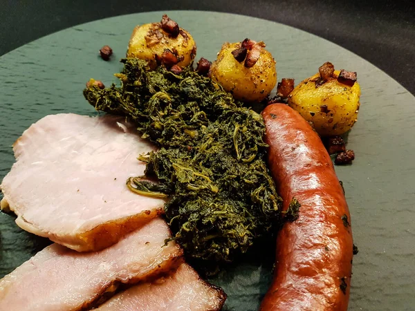 traditional northern german Food curly Kale with pork Bacon and sausages