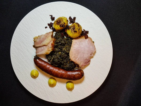 traditional northern german Food curly Kale with pork Bacon and sausages