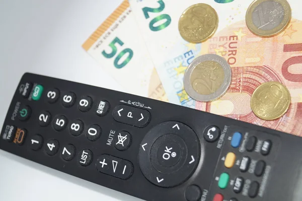 pay TV money and remote control