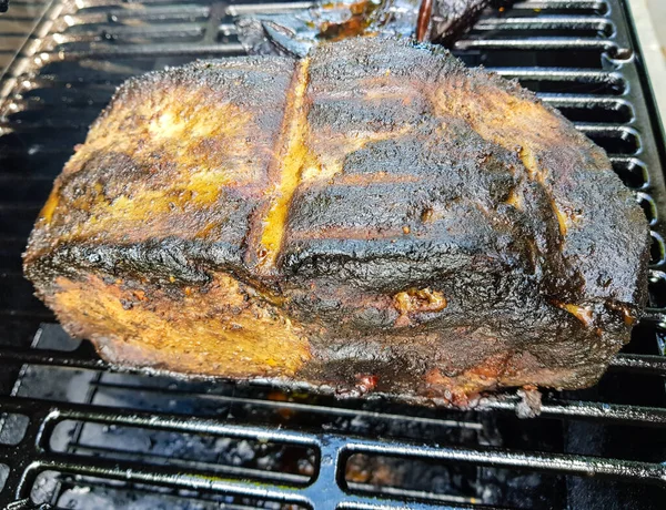 Pulled Pork of a pork shoulder roasted on a smoker