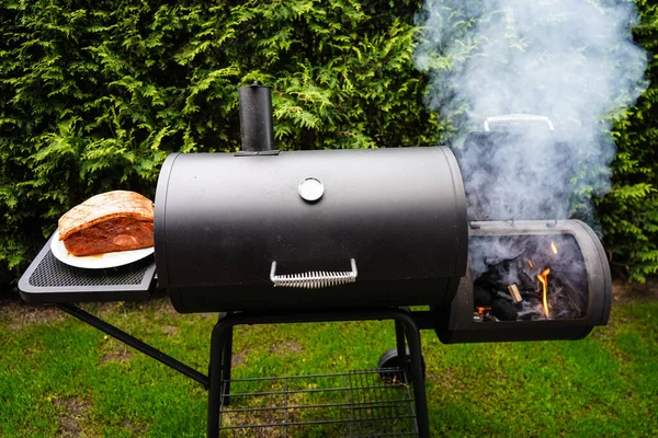 Pulled Pork of a pork shoulder roasted on a smoker