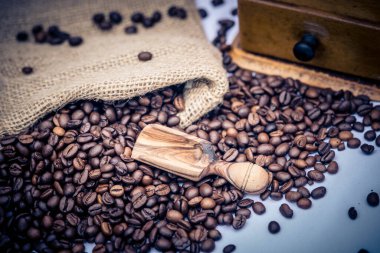 Kavrulmuş kahve çekirdekleri ve kahve öğütücüsü.