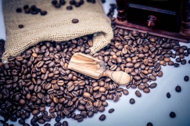 Kavrulmuş kahve çekirdekleri ve kahve öğütücüsü.