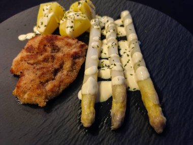 Schnitzel Steak with Asparagus officinalis a saisonal vegetable  clipart