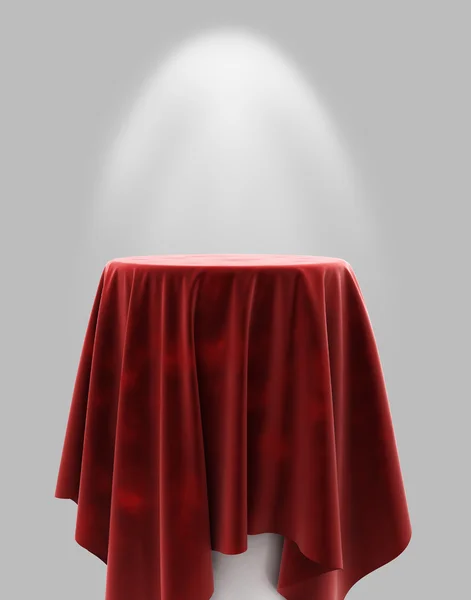 Tela de terciopelo rojo sobre un pedestal redondo sobre un fondo gris con il — Foto de Stock