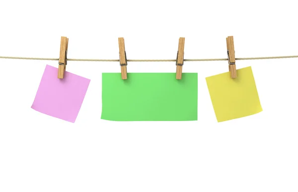 Hojas de papel de diferentes colores en pinzas de ropa unidas a un —  Fotos de Stock