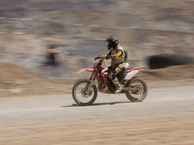 Motorbike driving in dust