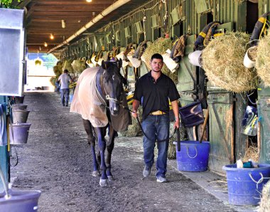 Dünyanın en iyi atlarına bakan geri kalmış işçiler için hayat zor. At battaniyeli Chad Brown ahırları Horse Haven, Saratoga Fleetphoto 'da.