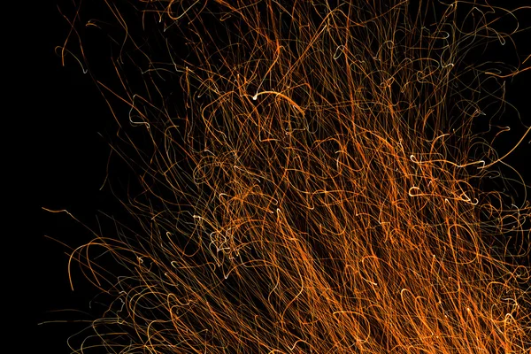 Dancing flames and sparks isolated on black — Stock Photo, Image