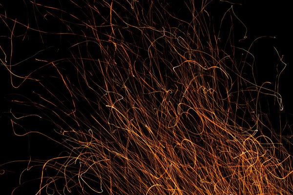 Dancing flames and sparks isolated on black — Stock Photo, Image