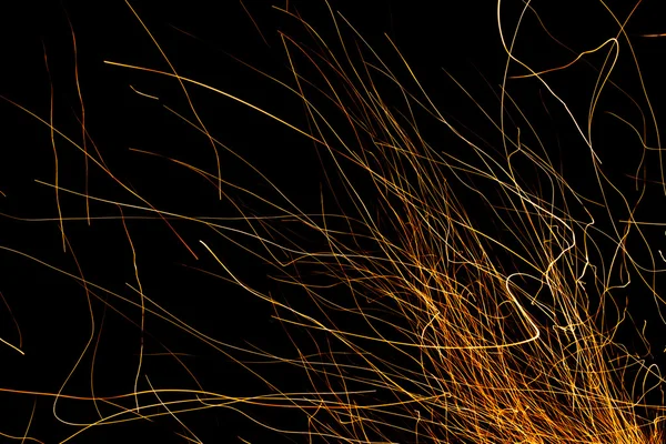 Dancing flames and sparks isolated on black — Stock Photo, Image