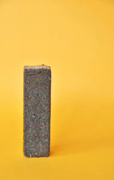 stock image Chalk Eraser in used condition isolated on yellow background 