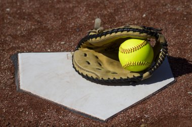 Fastpitch Catchers Mitt With Yellow Ball On Homeplate clipart