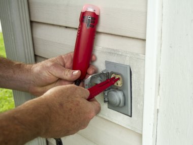 Electrician Testing A Outside Electrical Outlet clipart
