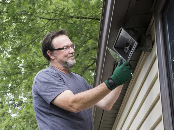 Electrician Talkng Glass Cover Off Outside Light — Stock Photo, Image