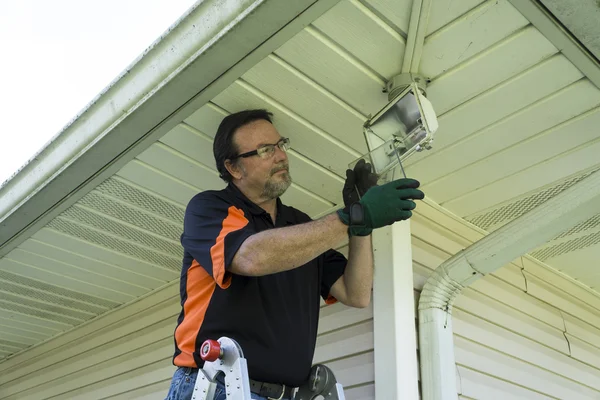 Electrician Taking Glass Cover Off Outside Light Fixture — Stock Photo, Image