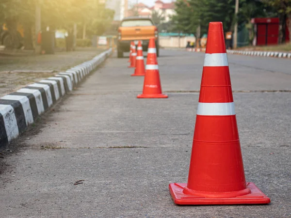 Beton zemine yerleştirilmiş turuncu trafik konileri.