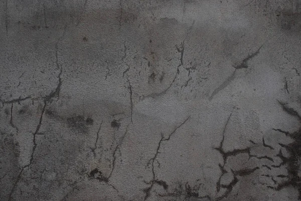 An old concrete wall with mortar cracks.