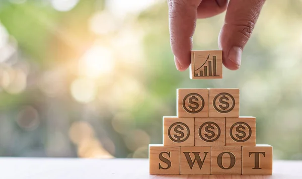 Eller, işe anlam katmak için önlerinde harfler ve semboller olan tahta blokları topluyor..