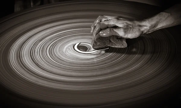 Man\'s hand on a potter\'s wheel