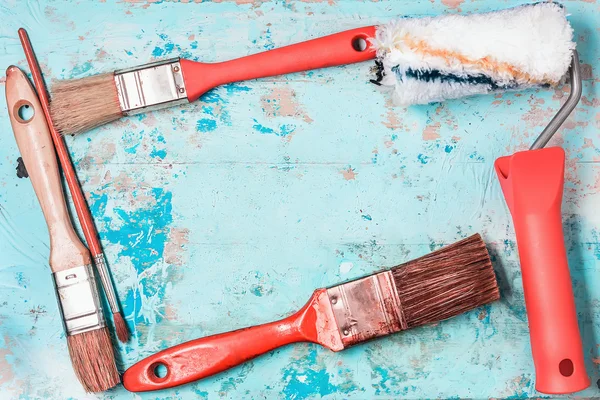 Paint Brushes On A Blue Wooden Background