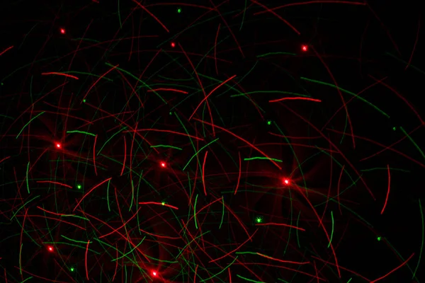 Patterns in red and green on the wall. Laser background. Party or disco concept.