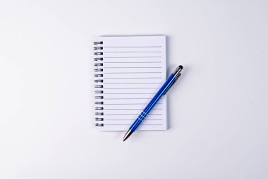 Beyaz arka planda kalem ve spiral defter. İzole et. İzole et. Uzayı kopyala Düz yatıyordu.