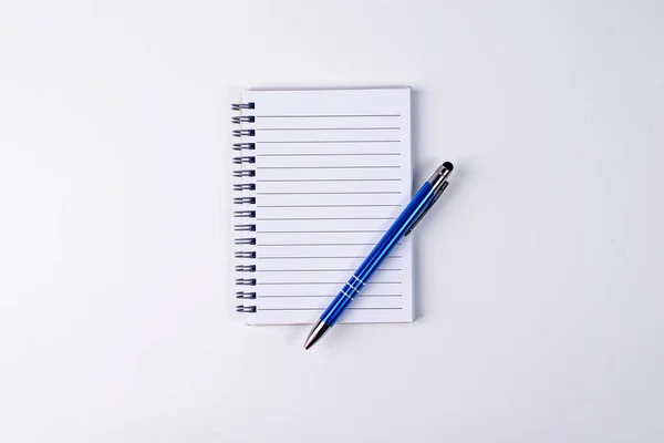 Pen and spiral notebook on white background. Isolate. Isolate. Copy space. Flat lay.