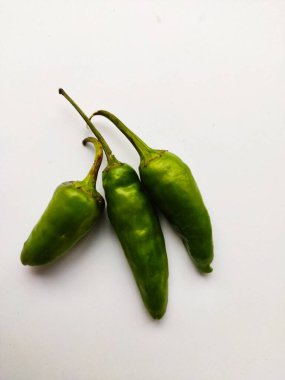 Beyaz arkaplanda sapı olan yeşil biberler